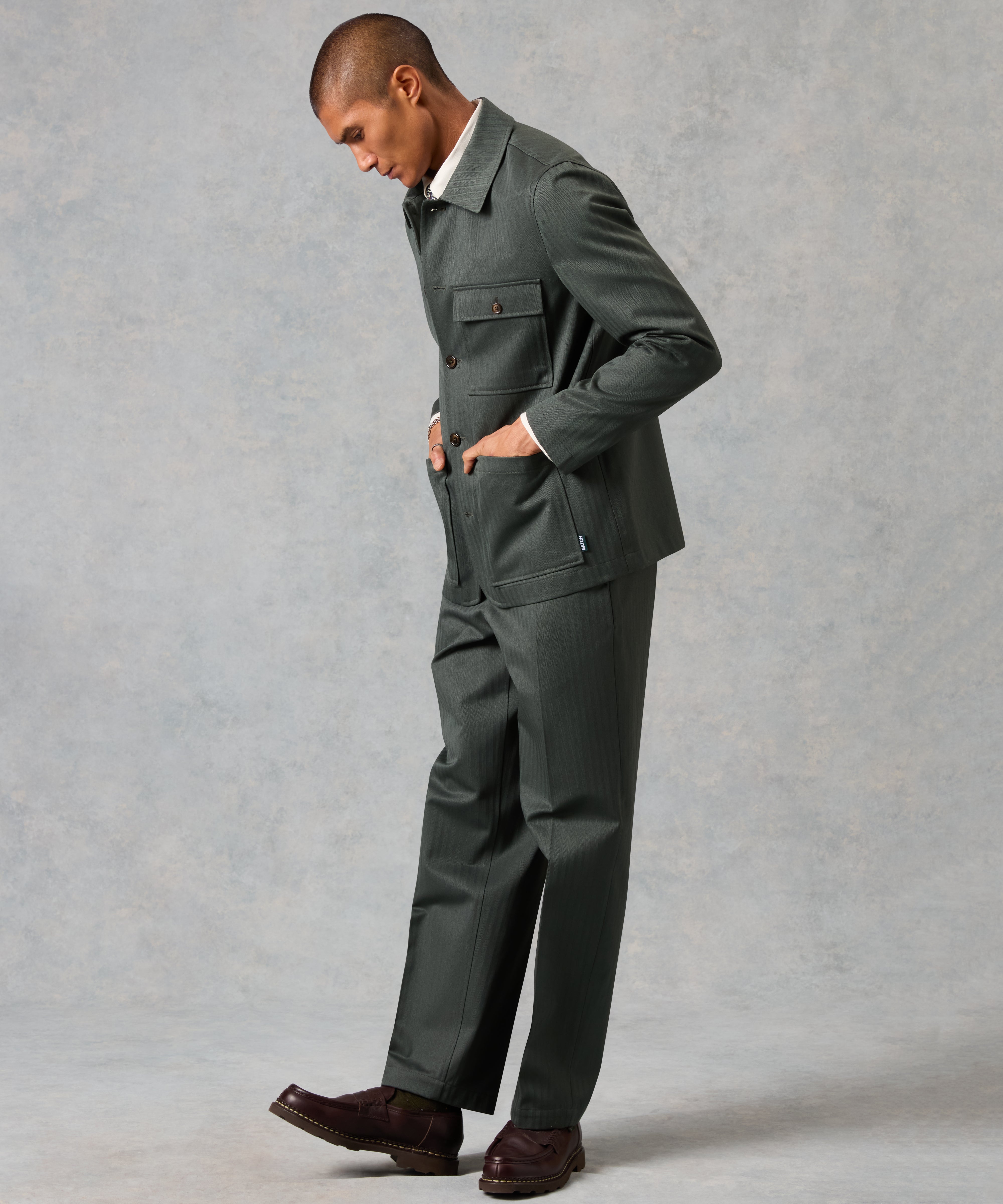 Man wearing a gray suit against a plain background