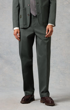 Green suit with a patterned shirt on a gray background