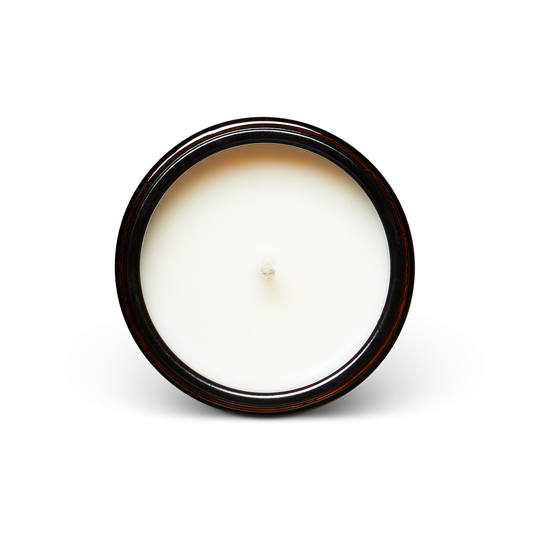 White candle in a black container on a white background