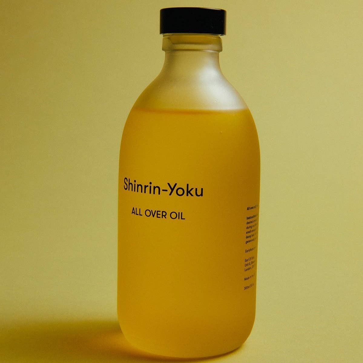 Bottle of Shinrin-Yoku all over oil on a yellow background