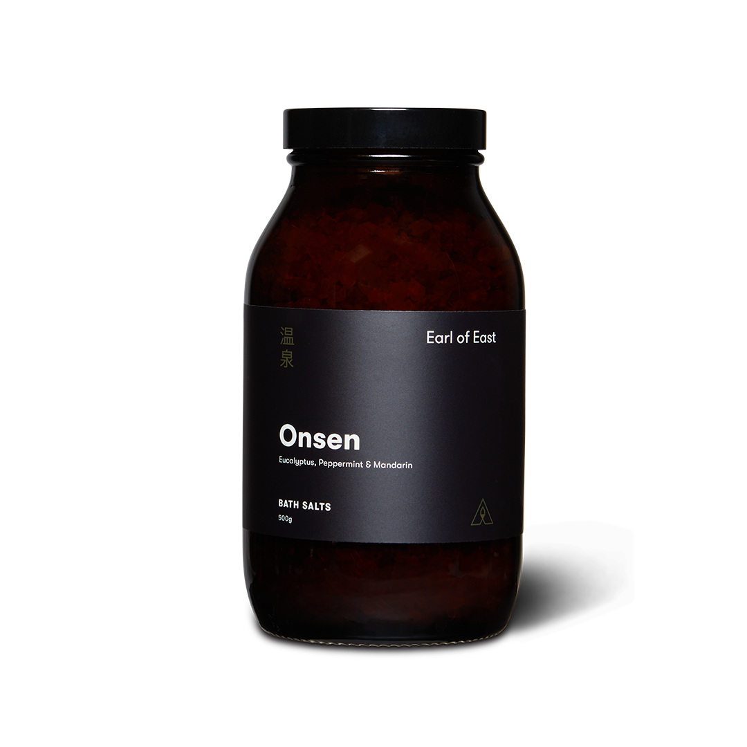 Bottle of 'Onsen' bath salts with a black label on a white background
